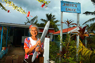 'Momma' Josie Sadaraka, 90 stands with the Melbourne 2006 Commonwealth Games Queen's Baton outside her home on the Cook Islands.